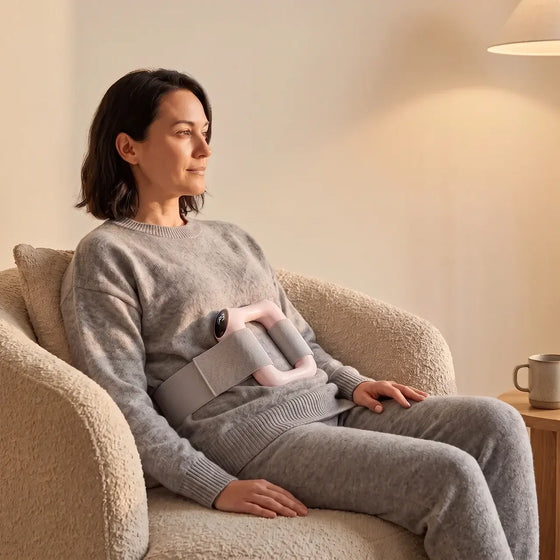 Reoviva Pro strapped to the thigh, display showing intensity level
